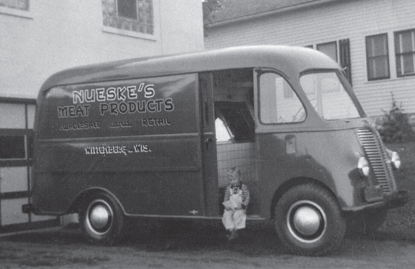 A young Bob Nueske, son of founder R. C. Nueske, looks over an invoice sitting on the edge of a 1940s International Harvester company delivery van. Contributed photo.